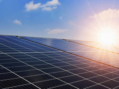 Solar panels with sunset and blue sky background. Clean power energy concept